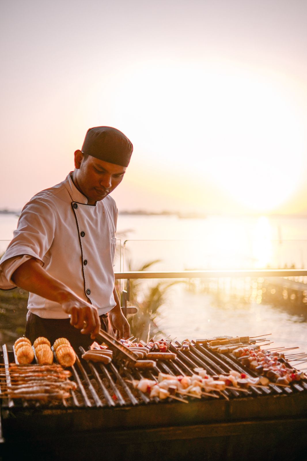 seorang chef sedang menggrill aneka menu BBQ